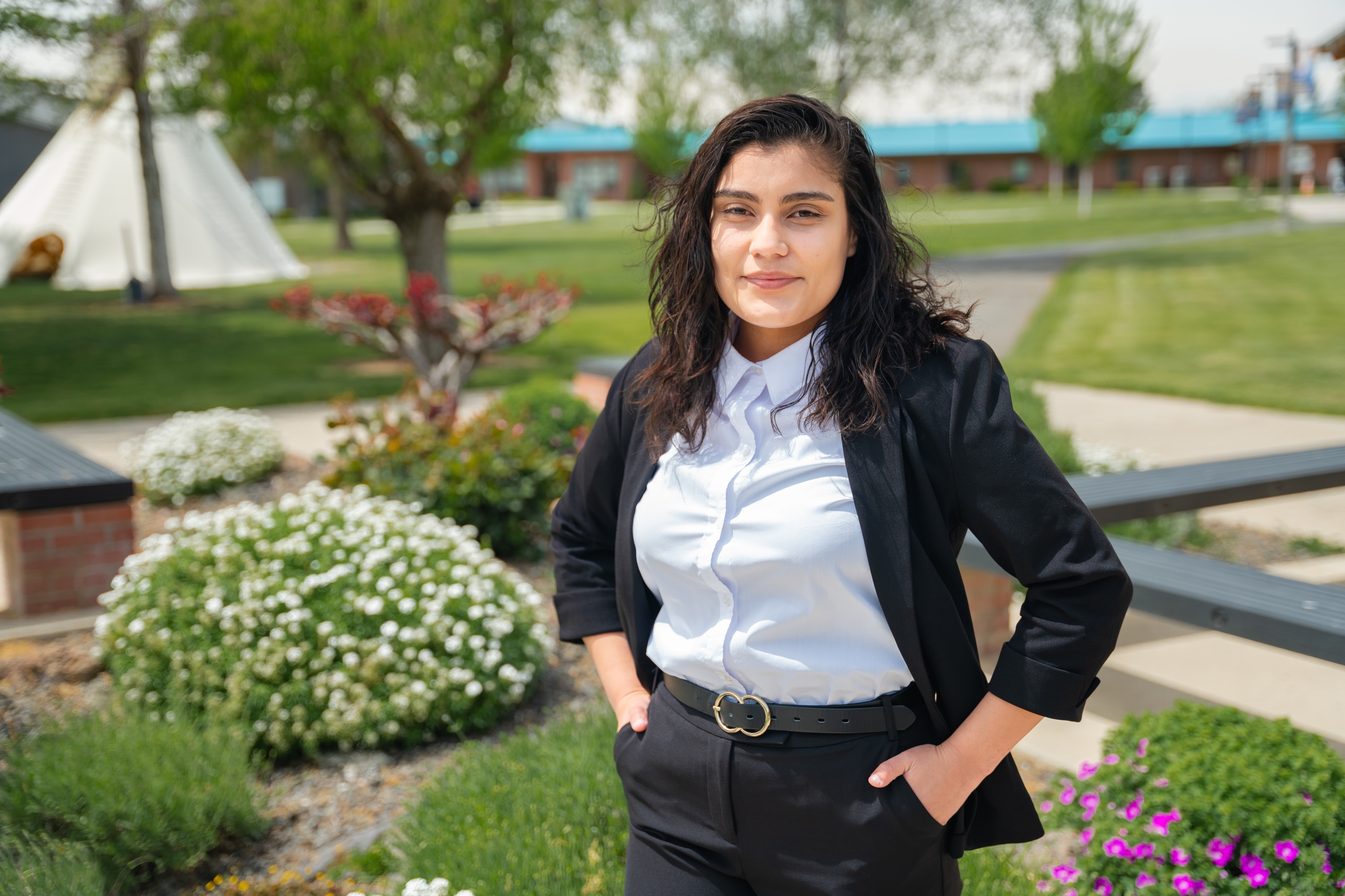 Yakima Valley Act Six recipient posing in front of Heritage University