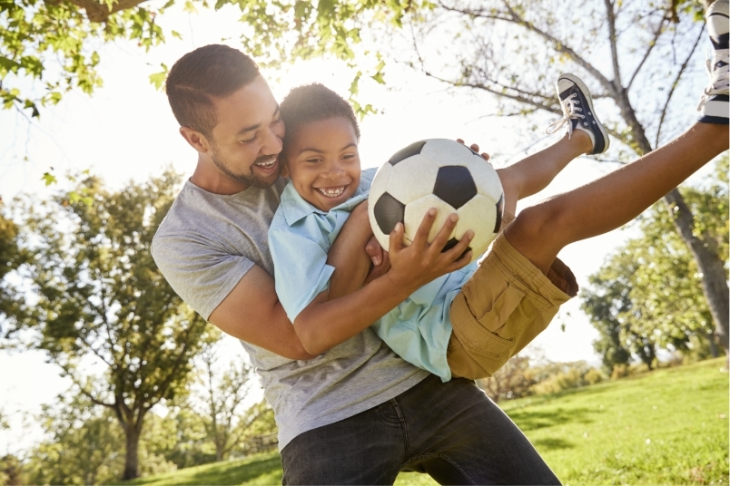 Dad son soccer stock